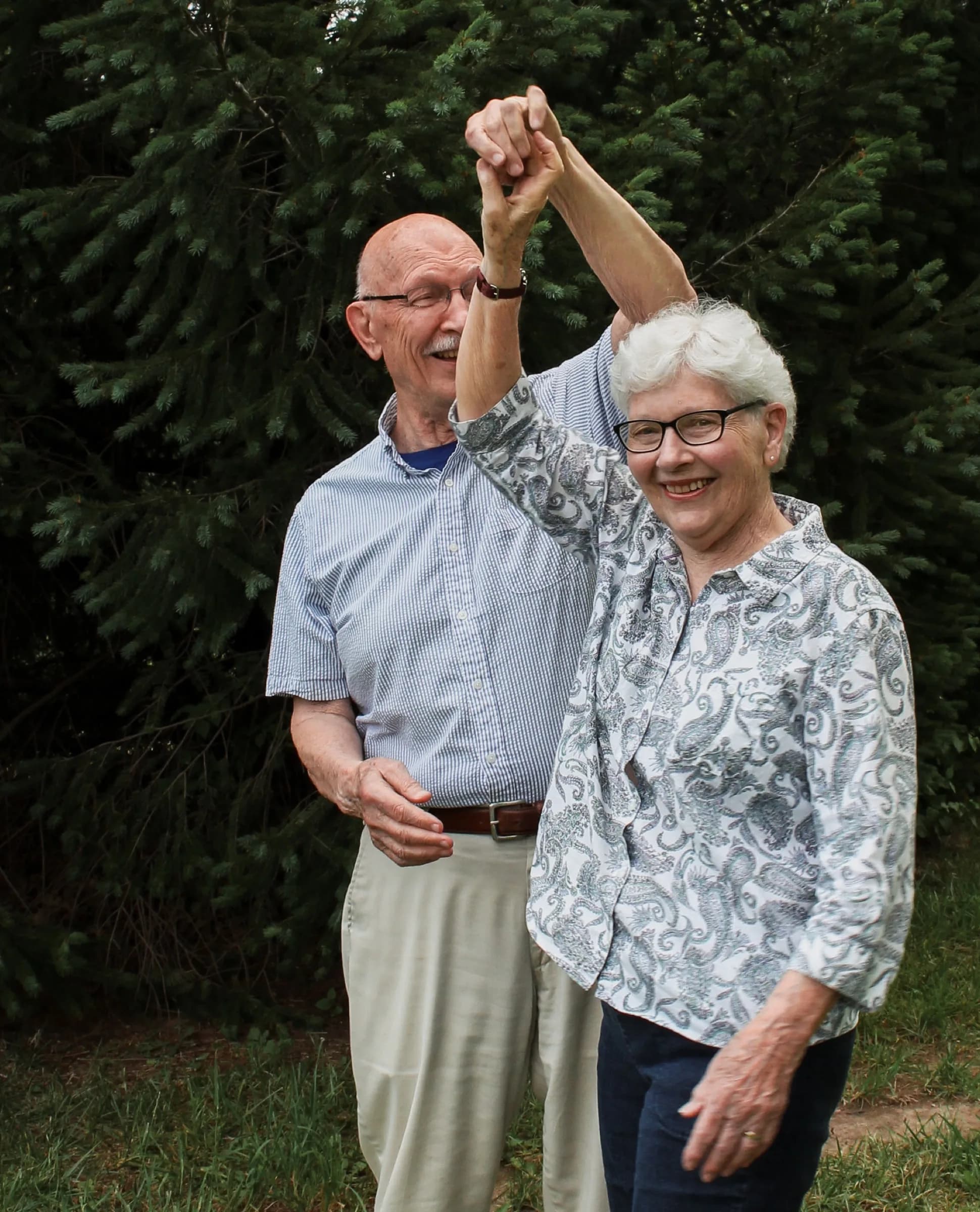 Older couple dancing outdoors