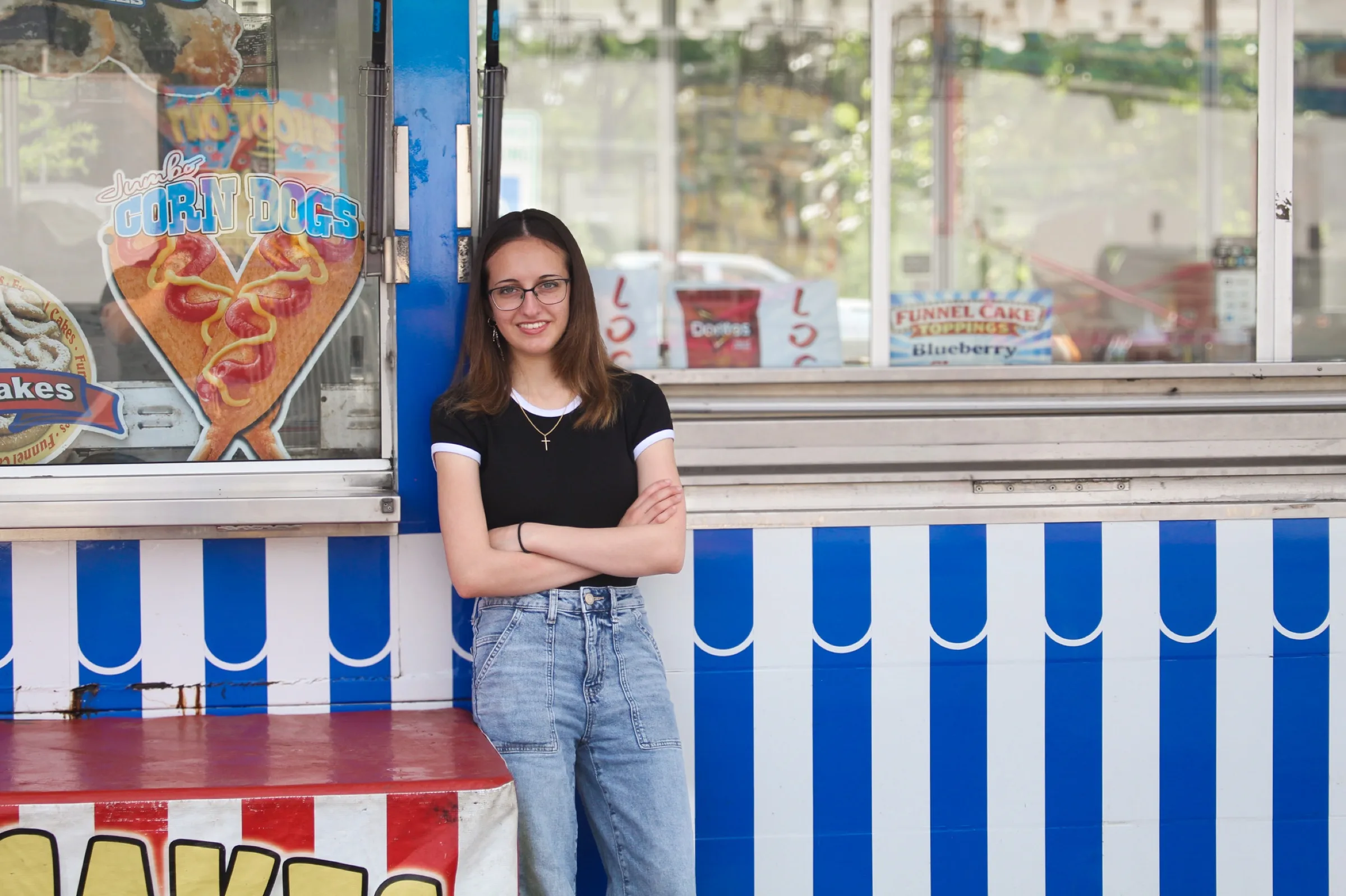 An individual portrait at a colorful fair stand