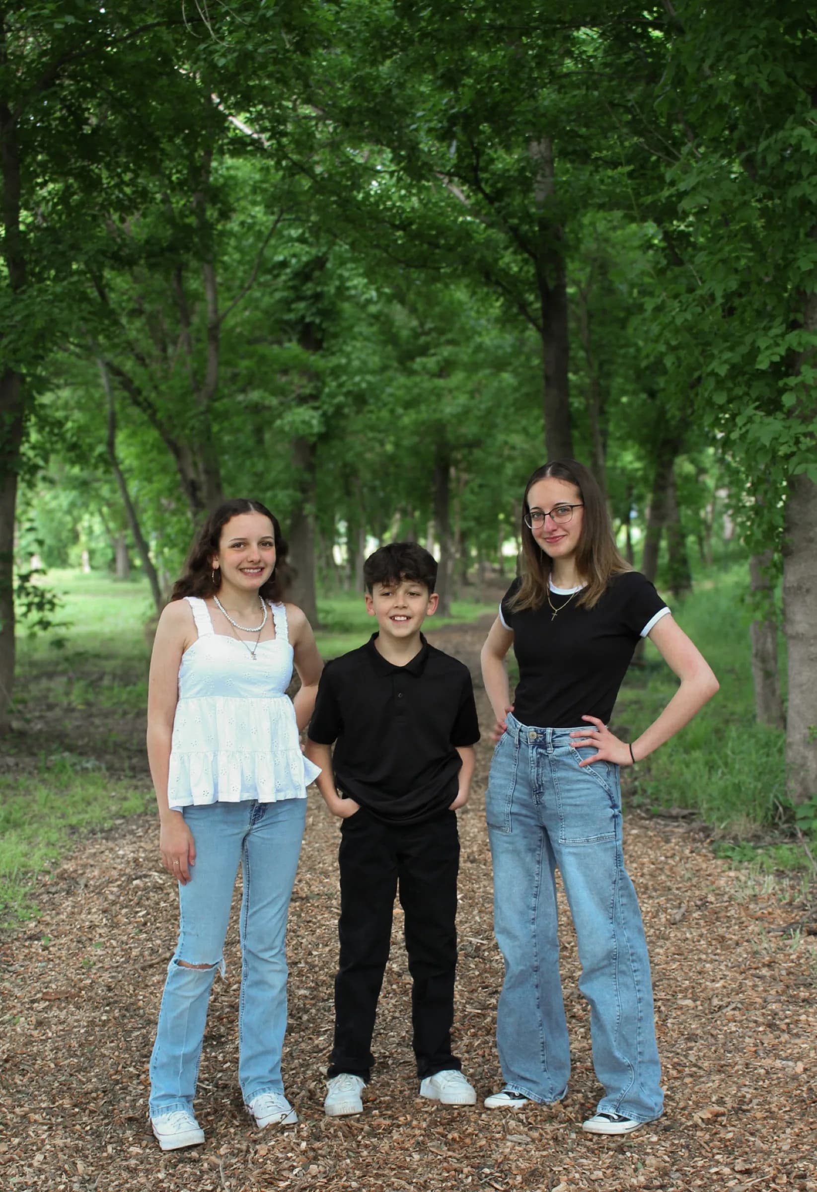 Three young people on a wooded path